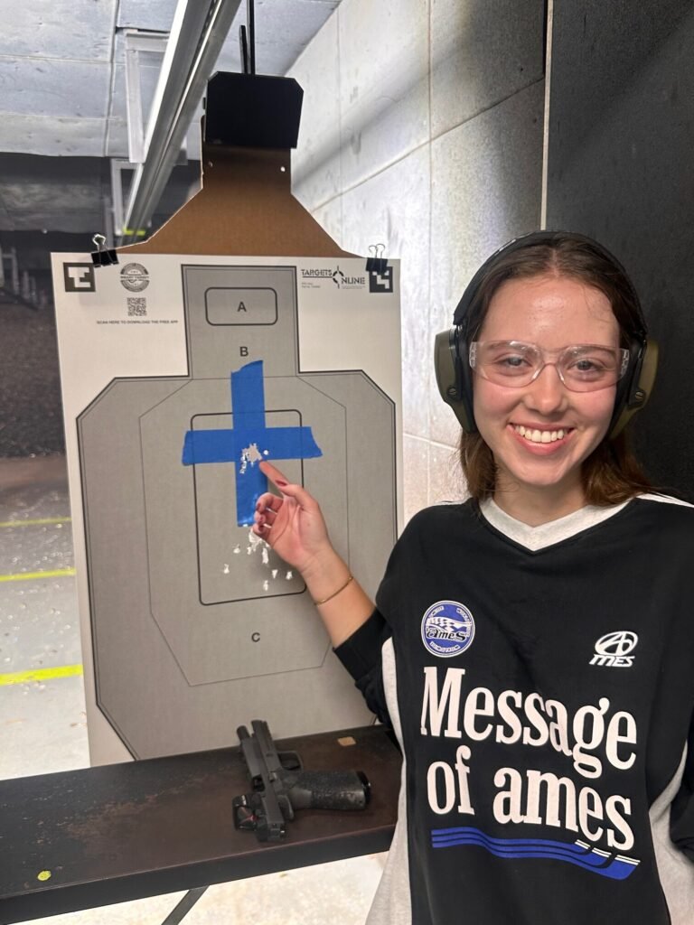 Smiling student with her target after Boca Raton gun training