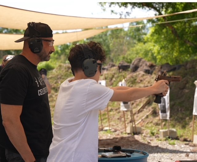 Instructor coaching a Boca Raton student through a pistol drill