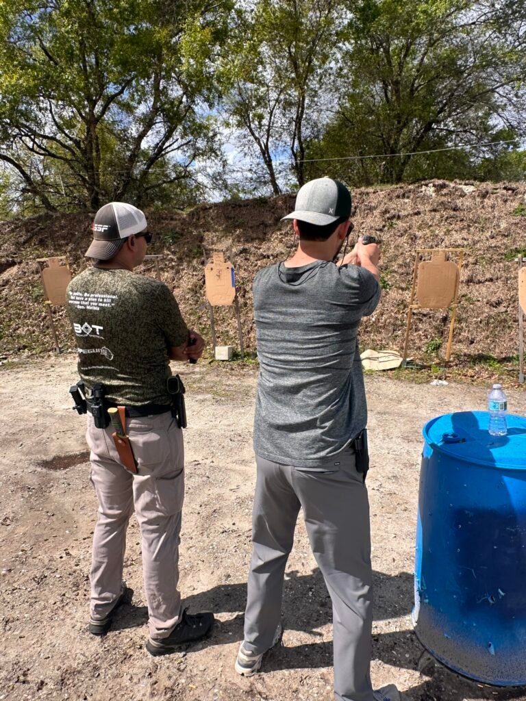 Instructor coaching a student during a firearm course