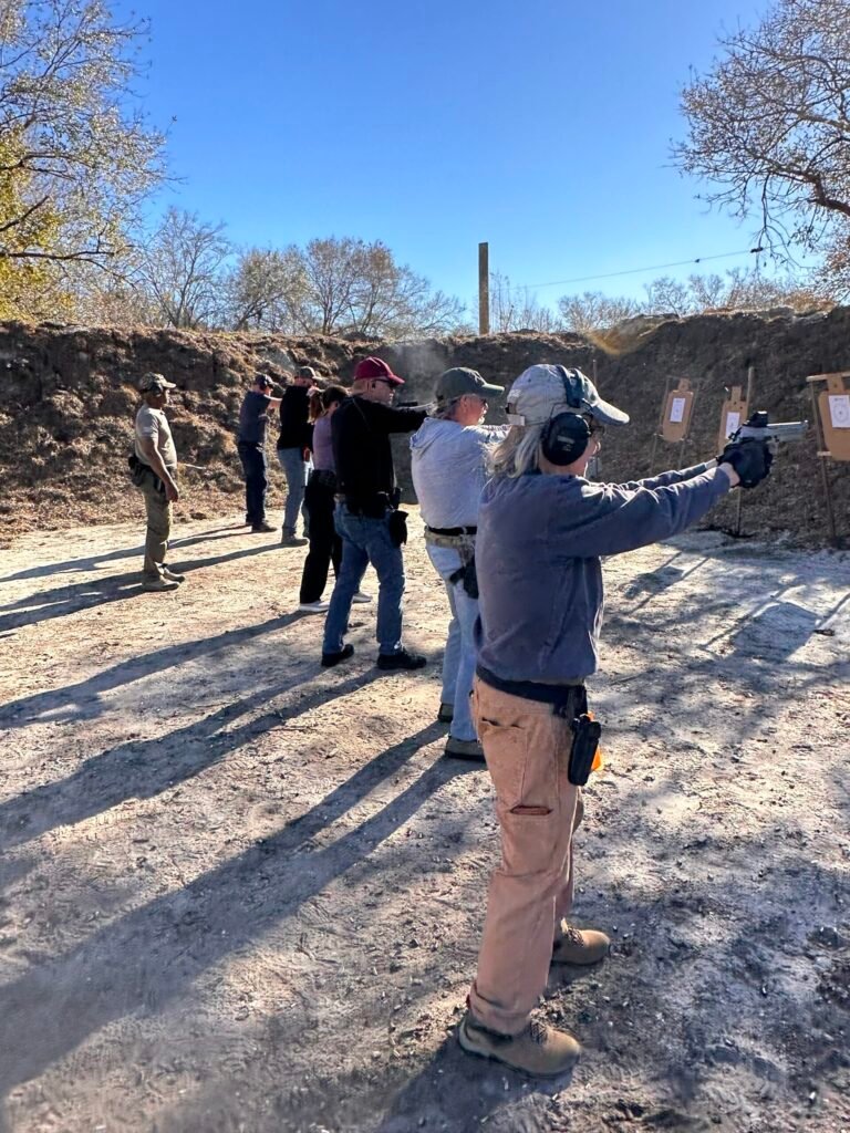 Students on the firing line at an outdoor pistol class near Lantana