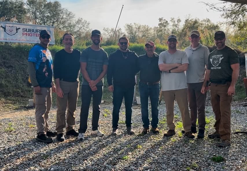 Group firearm training class standing together at the range