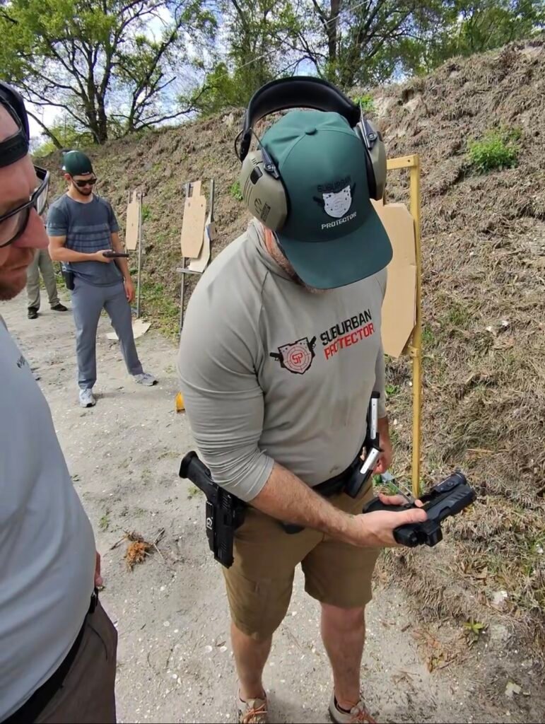 Instructor demonstrating pistol handling during defensive training