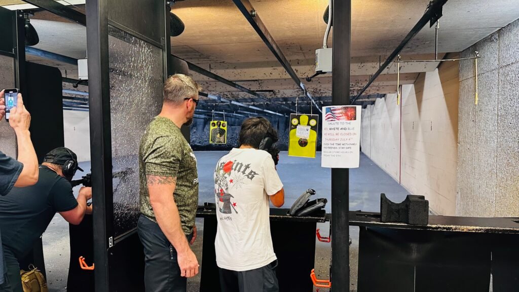 Instructor coaching students at an indoor range for house of worship security training