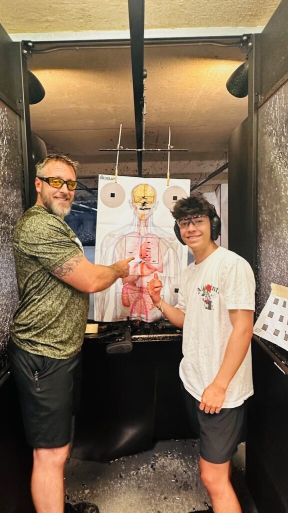 Instructor and student reviewing a target during a private lesson