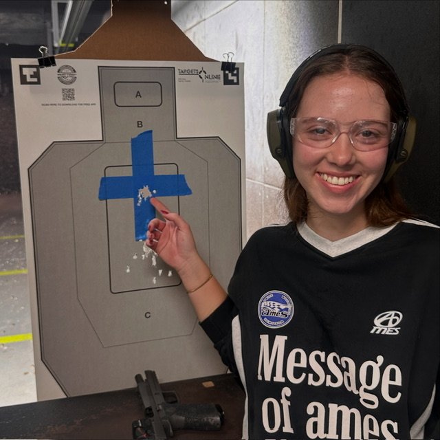 Private shooting lesson student showing her target