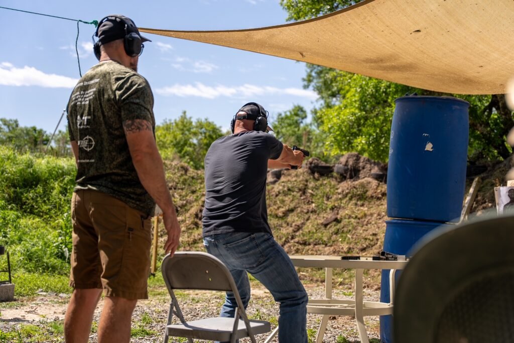 Instructor watching a student shoot at the outdoor range