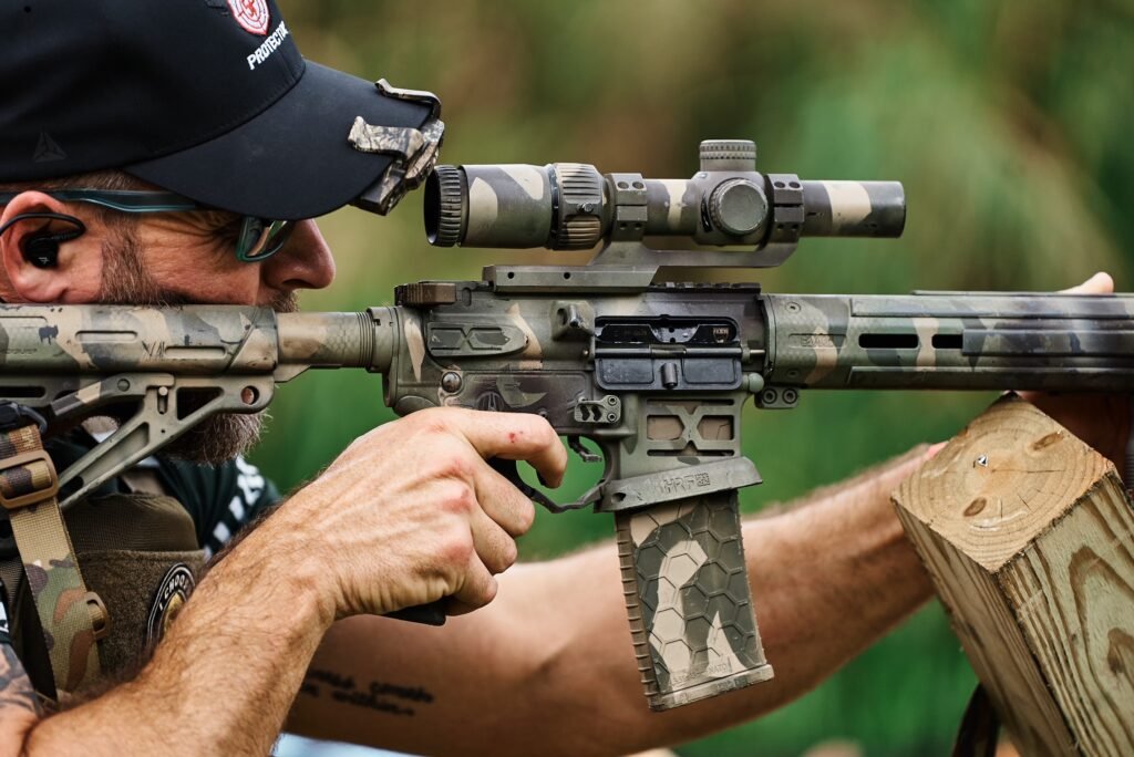 Student aiming a rifle with an optic during rifle training