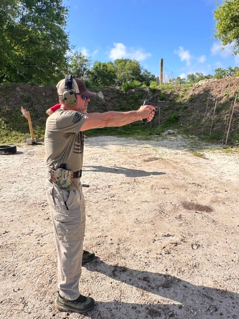 Student working on two-handed shooting at the outdoor range