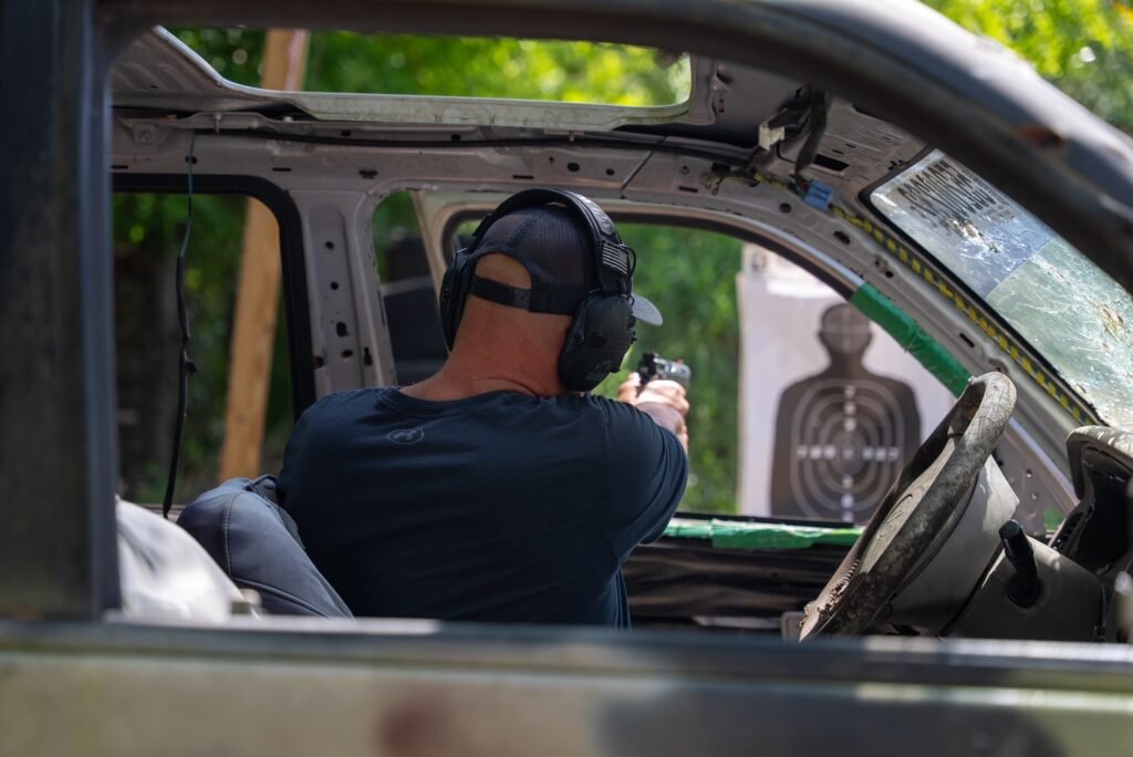 Student shooting from inside a vehicle during defensive training