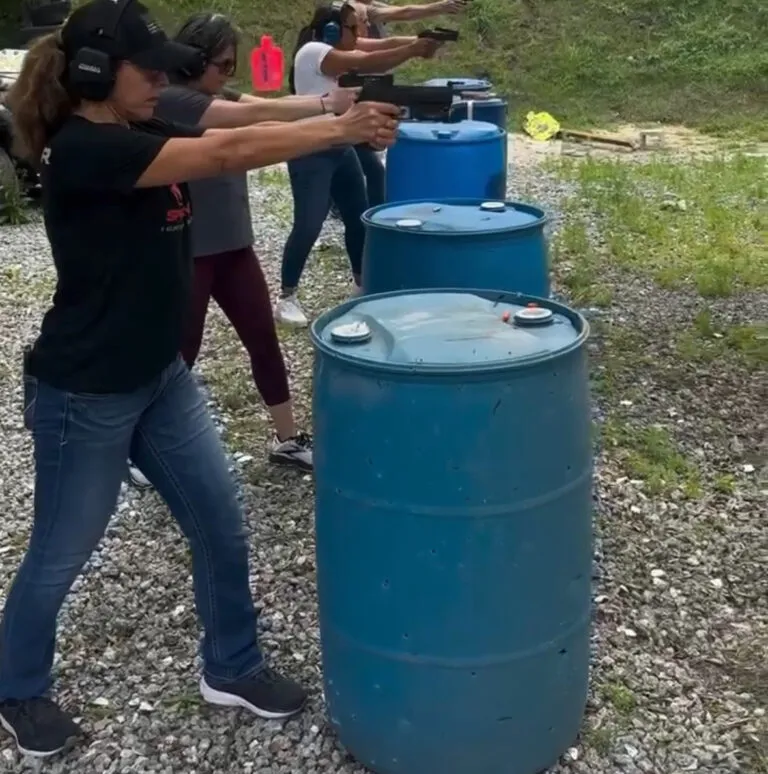 Woman practicing pistol shooting at an outdoor range
