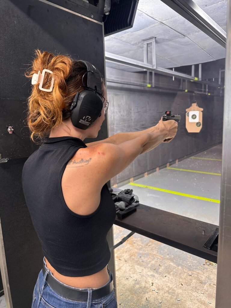 Woman training with a handgun during EmpowHER women's firearm training